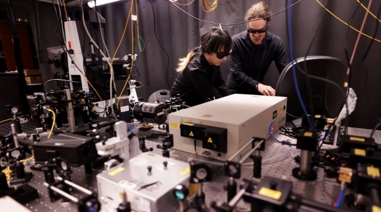 Zhaohan Jiang, a Ph.D. student in electrical and computer engineering, and Matthias Florian, research investigator in the electrical engineering and computer science department, prepare for a laser experiment in the Excitonics and Photonics (ExP) Lab.