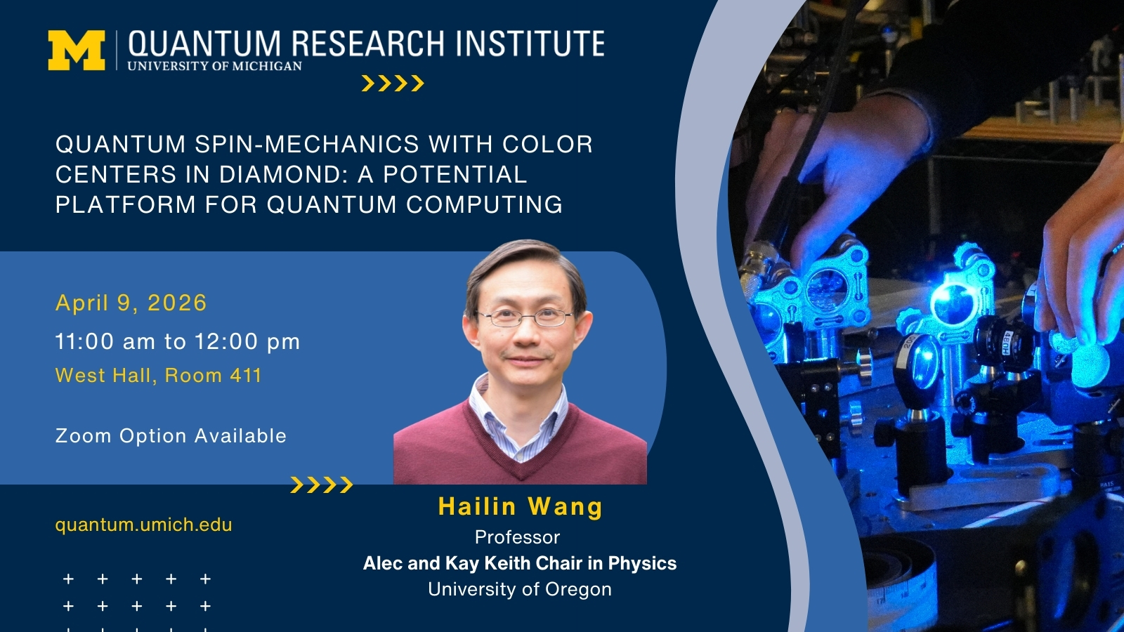A promotional graphic for the Quantum Research Institute at the University of Michigan, advertising a lecture titled "Quantum Spin-Mechanics with Color Centers in Diamond: A Potential Platform for Quantum Computing." The event is scheduled for April 9, 2026, from 11:00 am to 12:00 pm, at West Hall, Room 411, with a Zoom option available. The speaker is Hailin Wang, Professor and Alec and Kay Keith Chair in Physics at the University of Oregon. The graphic features the Quantum Research Institute branding, a person in a maroon sweater and collared shirt, and an image of hands operating blue-lit scientific equipment. The website quantum.umich.edu is listed.