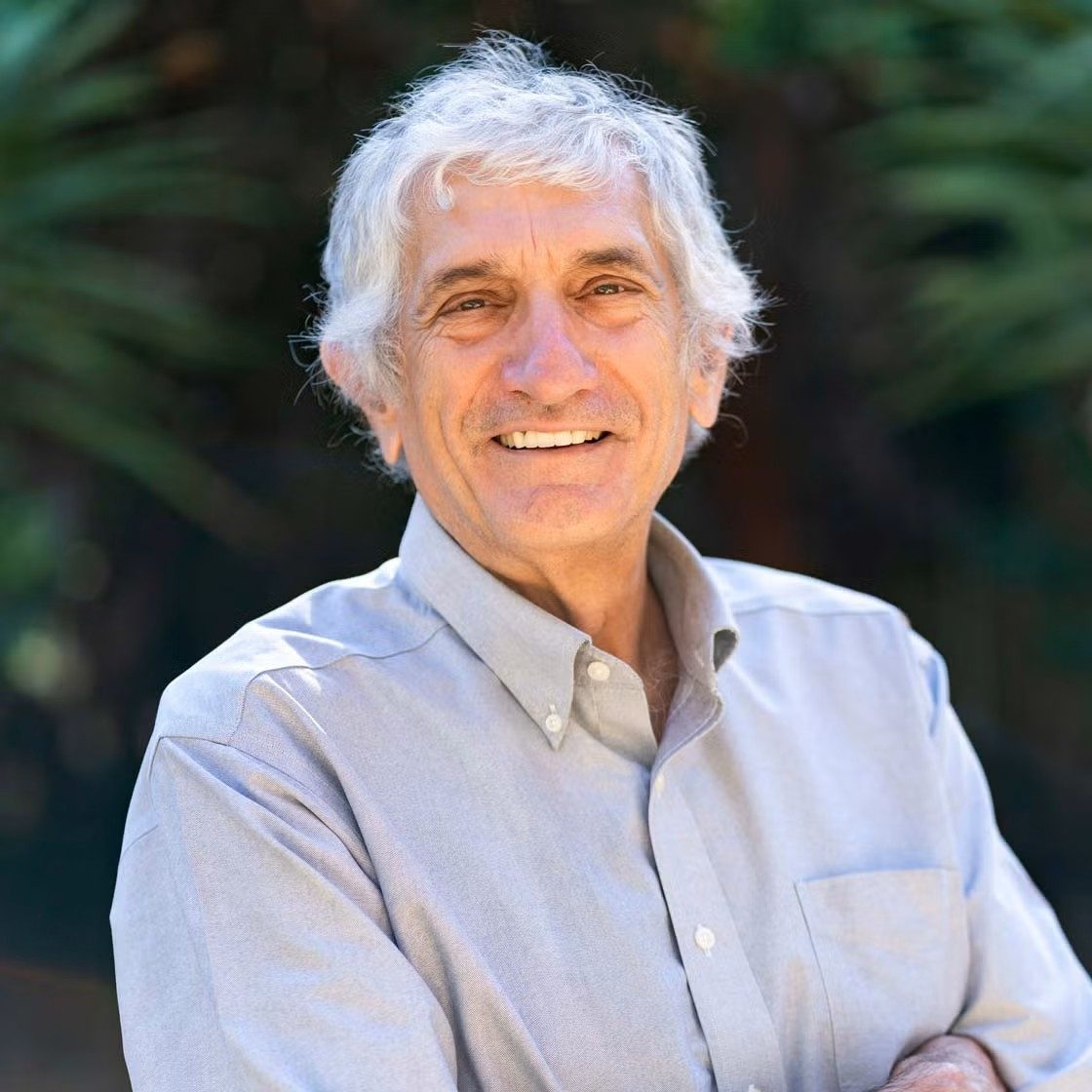 Headshot, smiling and wearing a collared shirt